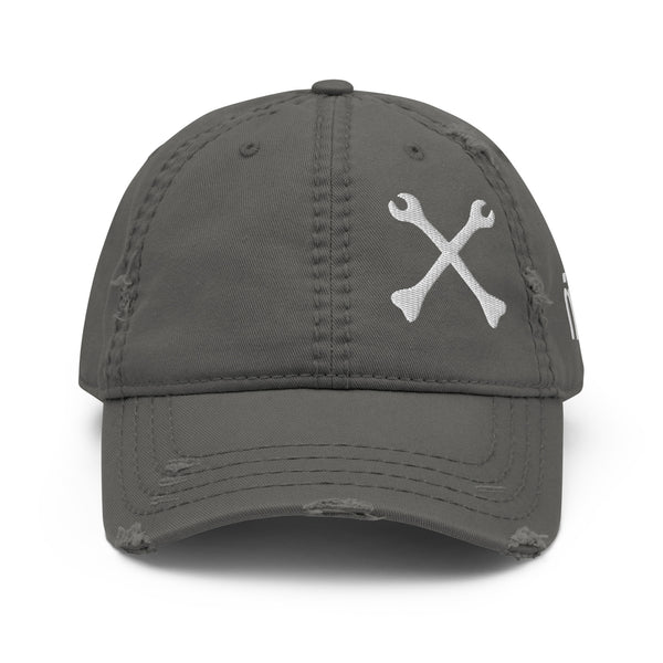 Cross Bones distressed dad hat in charcoal grey, front view showing the embroidered crossed-wrenches mark